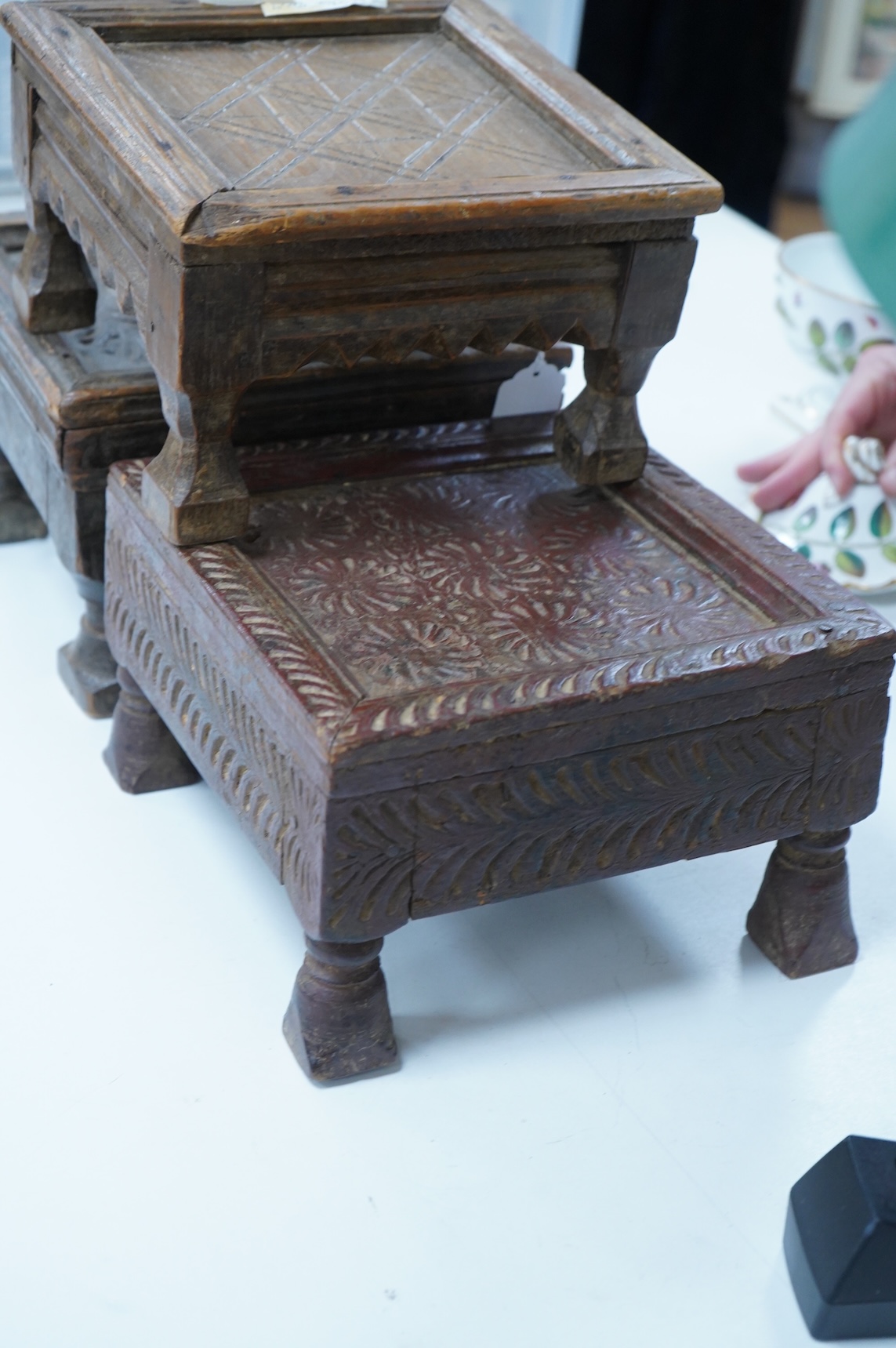 Three Indian carved wood stools or small tables, largest 27cm wide